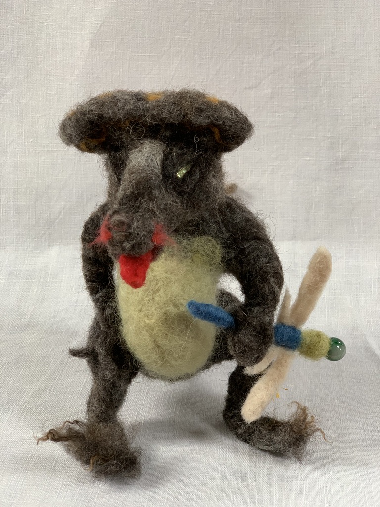 Needle-felted dragon holding a dragonfly for lunch.