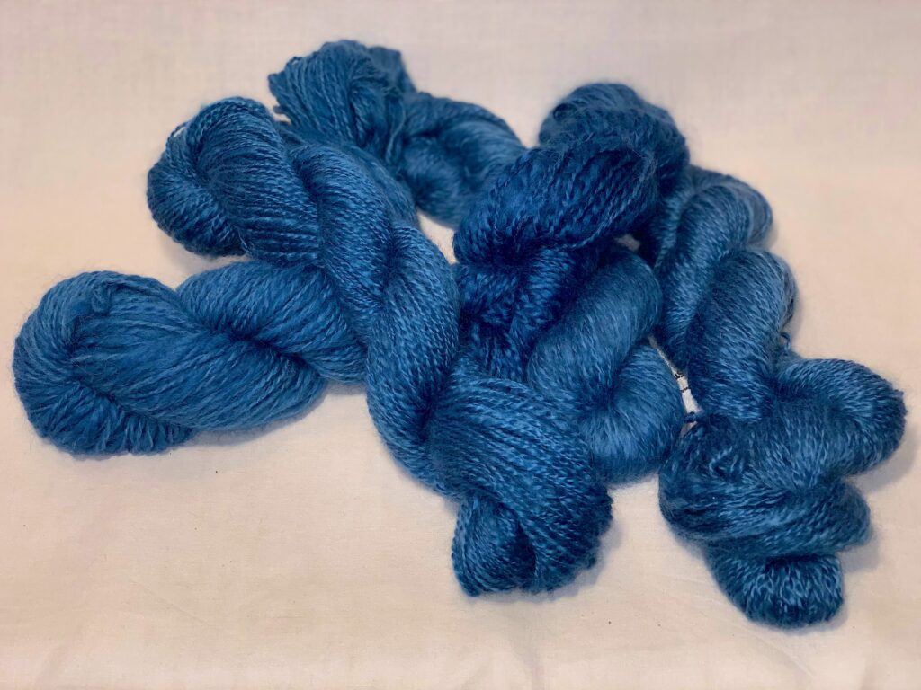 Indigo: Handspun yarn dyed deep blue with indigo.