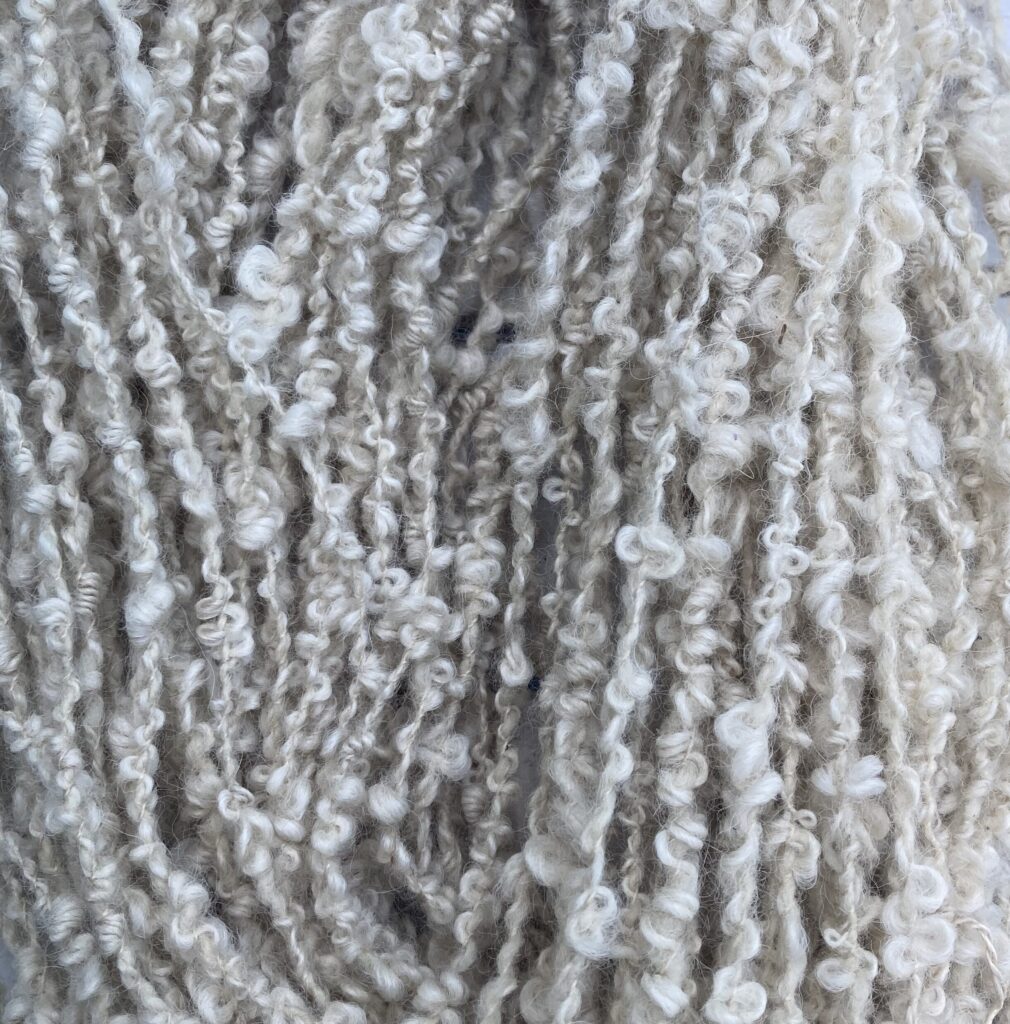 Lichen-dyed alpaca bouclé — parchment shades, with texture doing the talking.